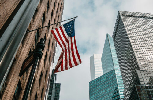 American flag displayed among city buildings